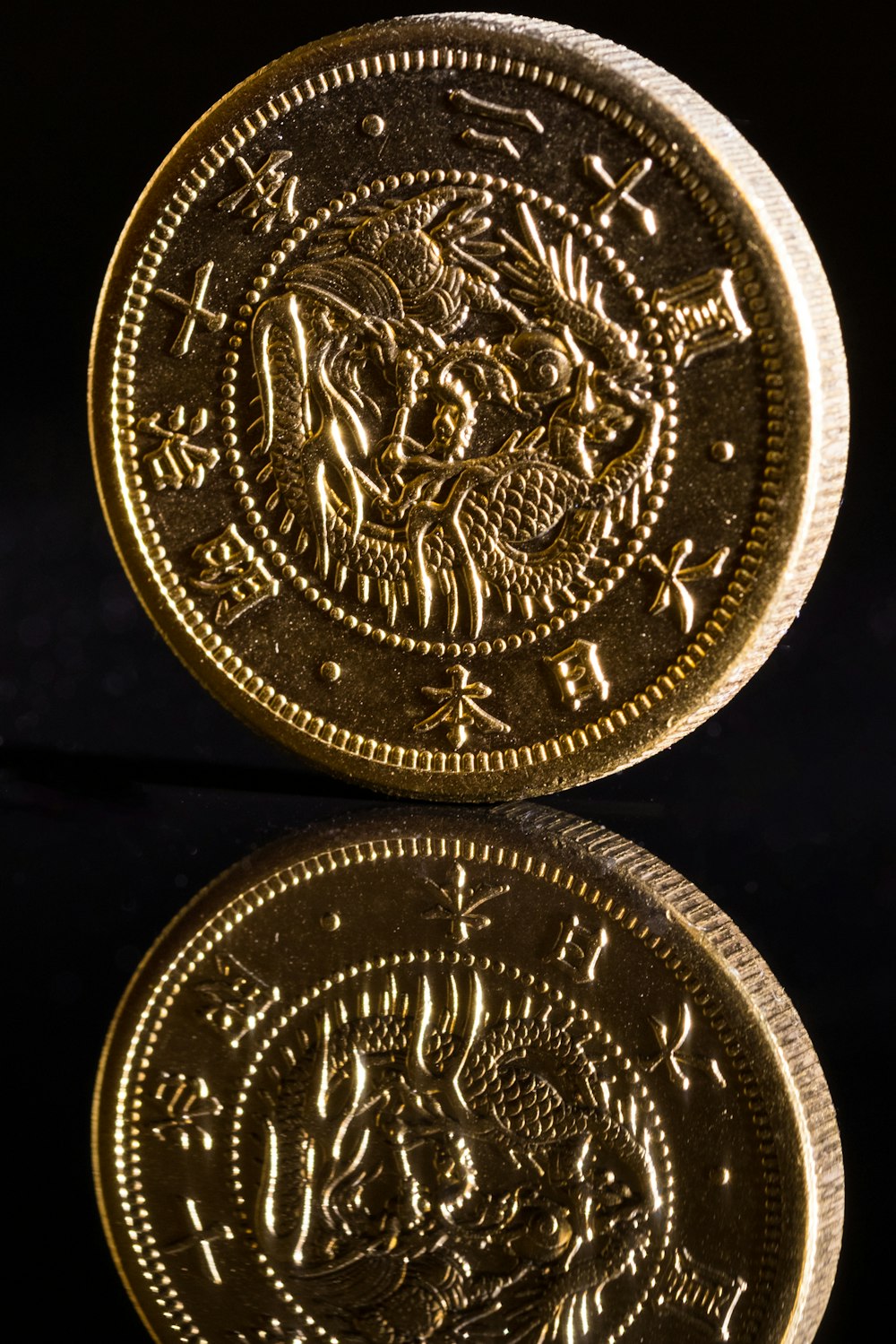 silver round coin on black textile