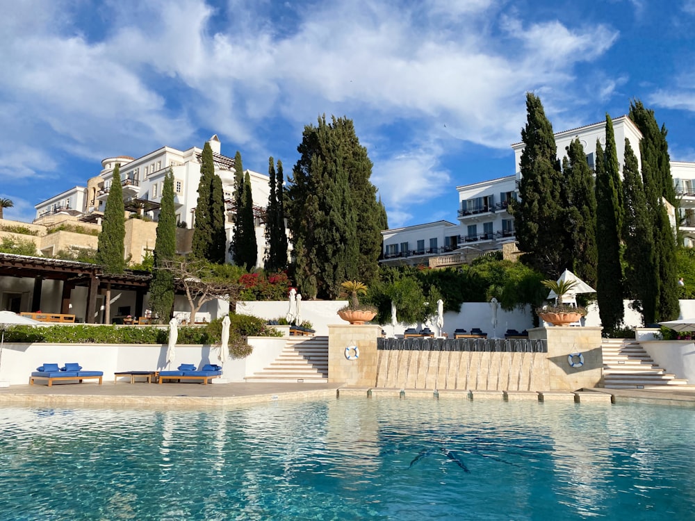 white concrete building near swimming pool during daytime