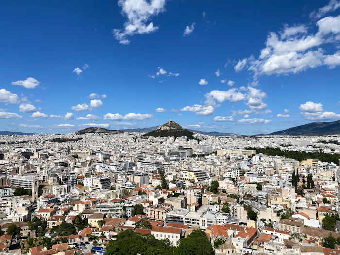 Athens spreading to the hills under a wide sky. The former airport lies south of this view.