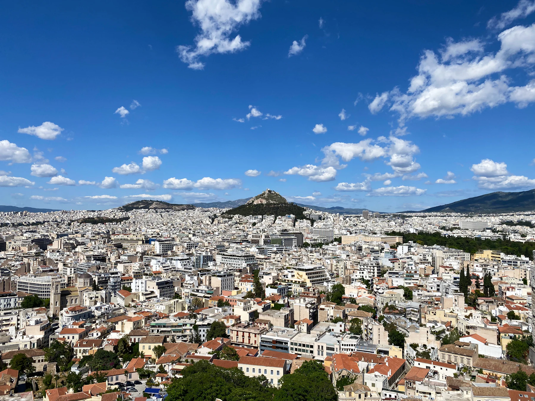 Athens spreading to the hills under a wide sky. The former airport lies south of this view.