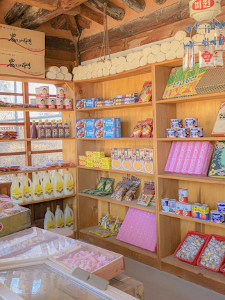 Close-up of vibrant Thai packaged goods neatly arranged on shelves.