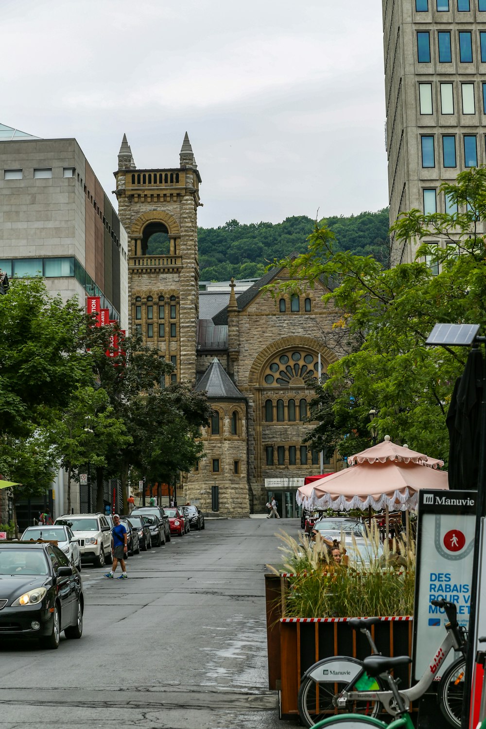 cars parked beside brown concrete building during daytime