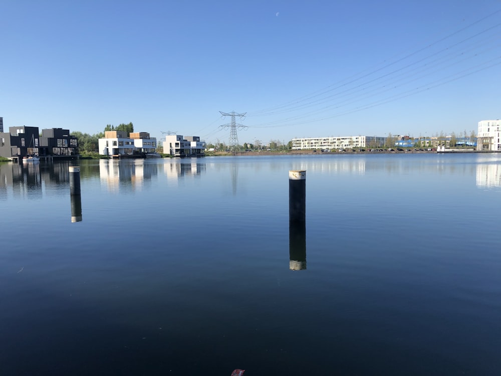 body of water near city buildings during daytime