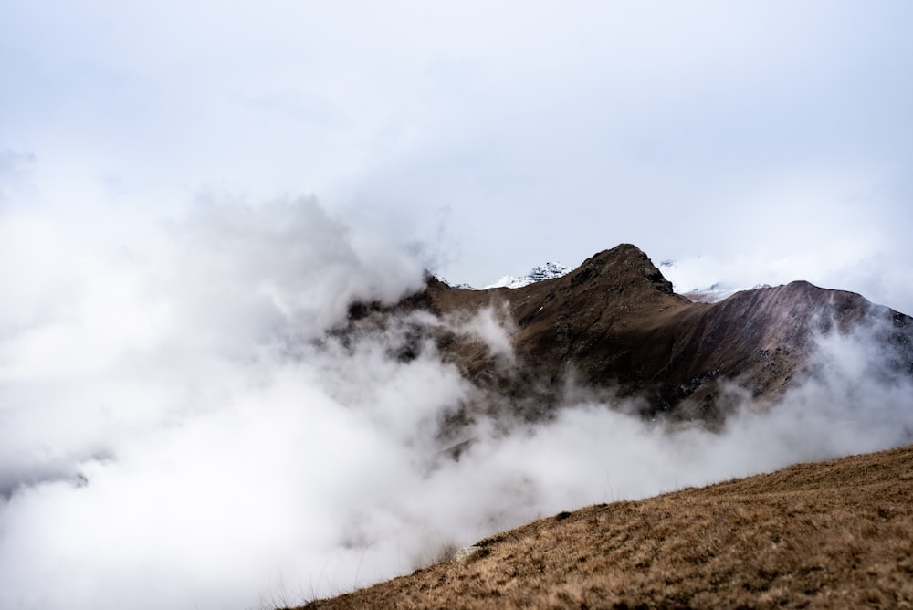 brown mountain under white clouds during daytime