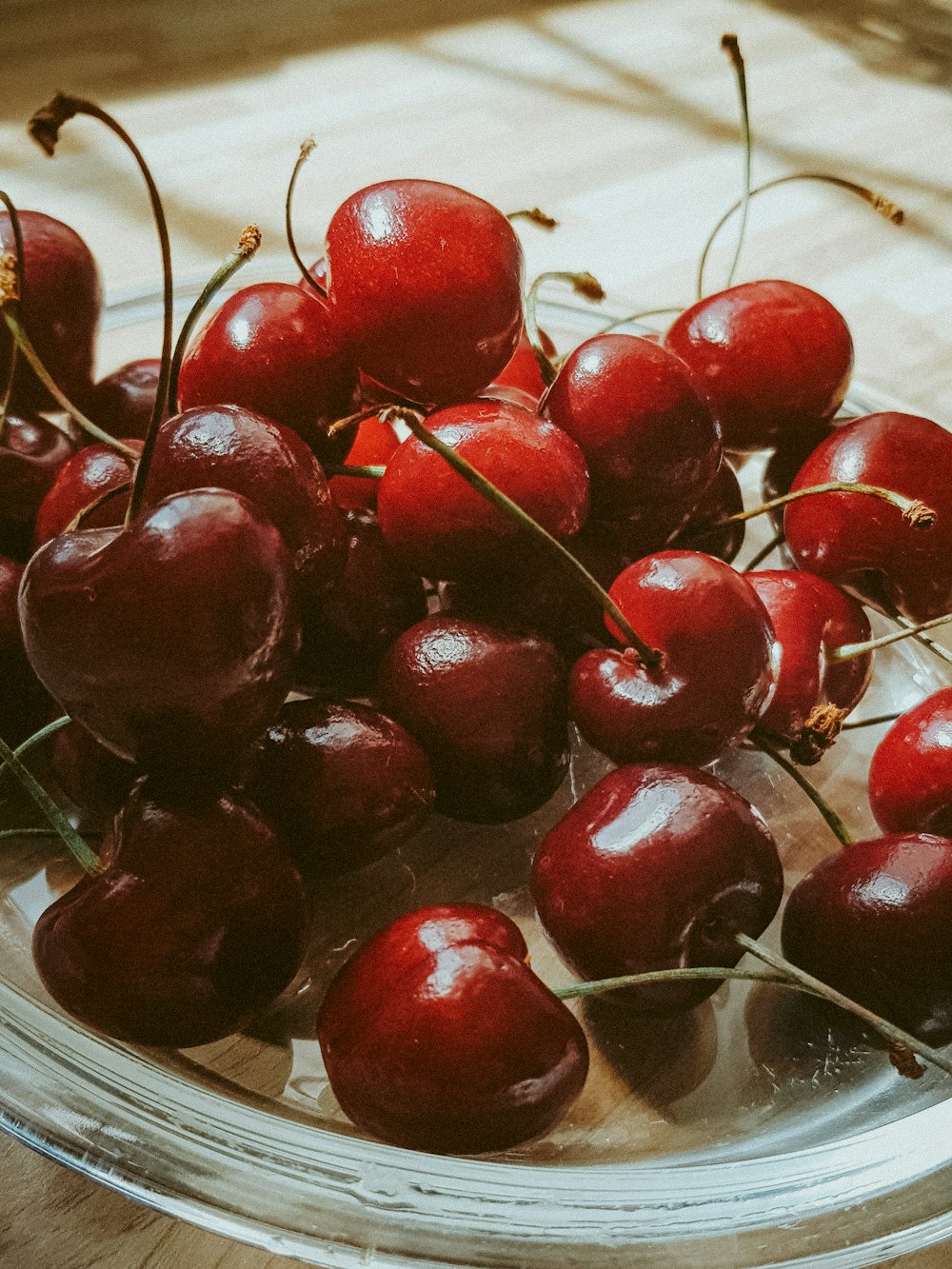 red cherries on white ceramic plate