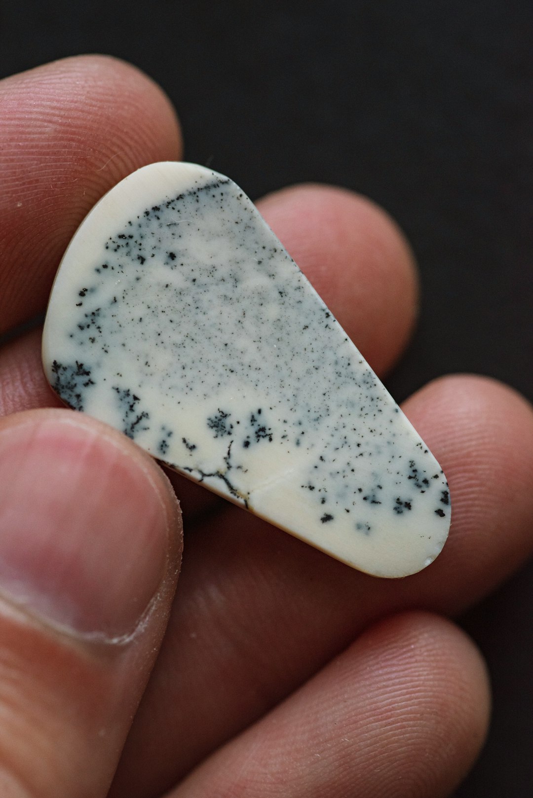 white rectangular ornament on persons hand