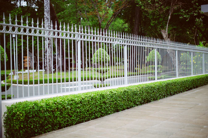 White wooden fence near green grass field