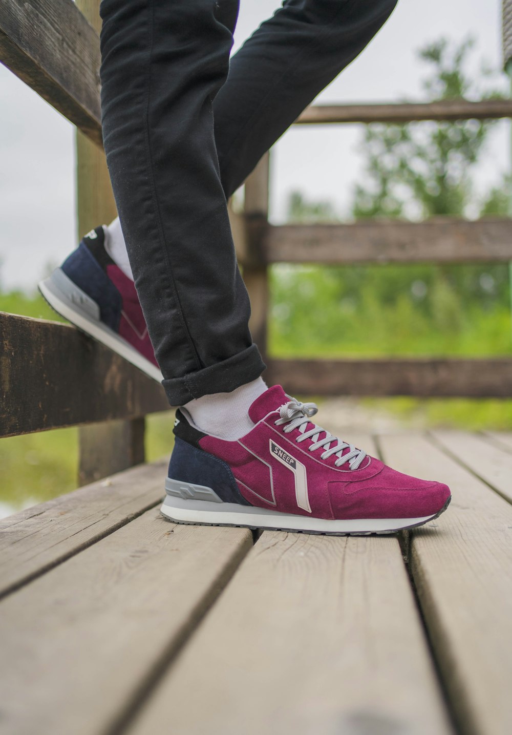 person in pink and white nike sneakers