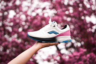 white and blue nike athletic shoe