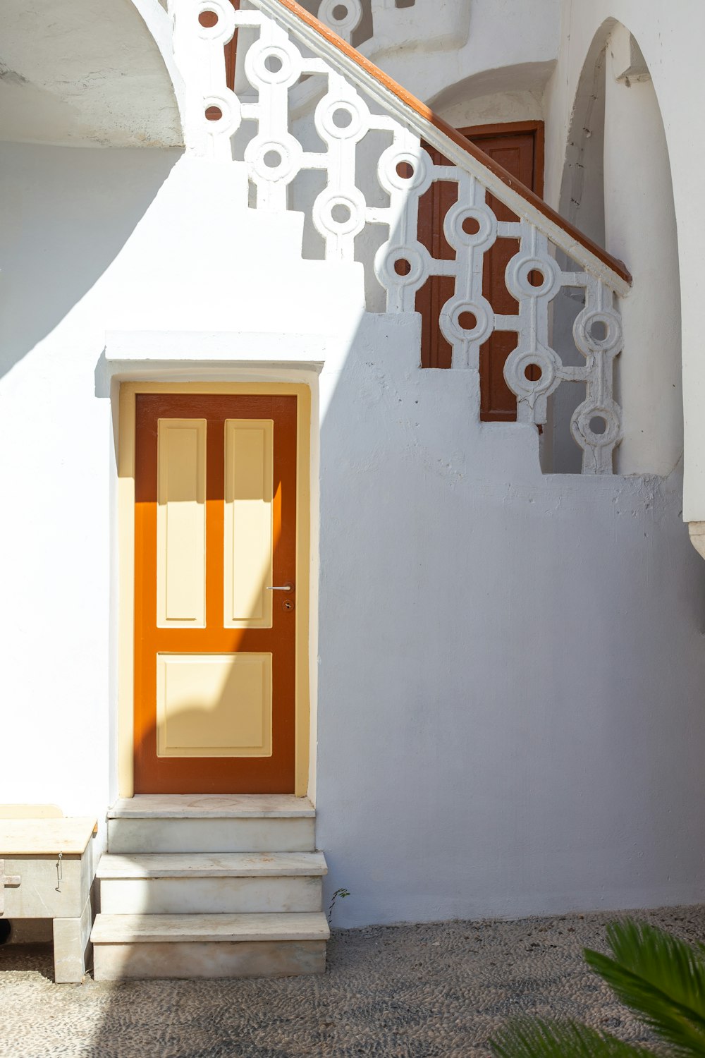 brown wooden door on white concrete wall