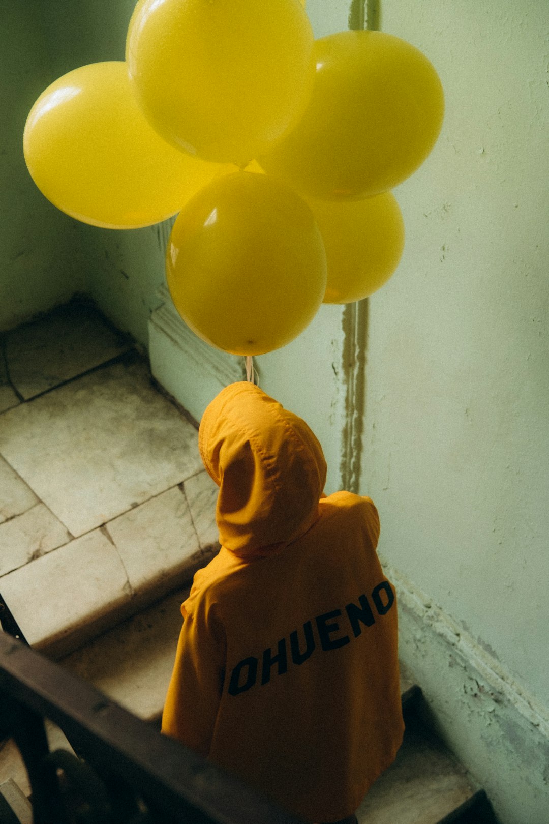 yellow and white balloons on white ceramic tiles