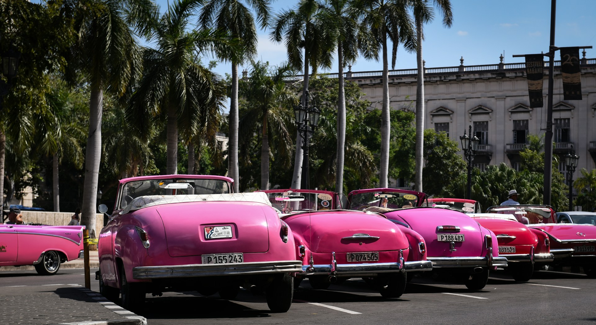 pink convertible car on road during daytime