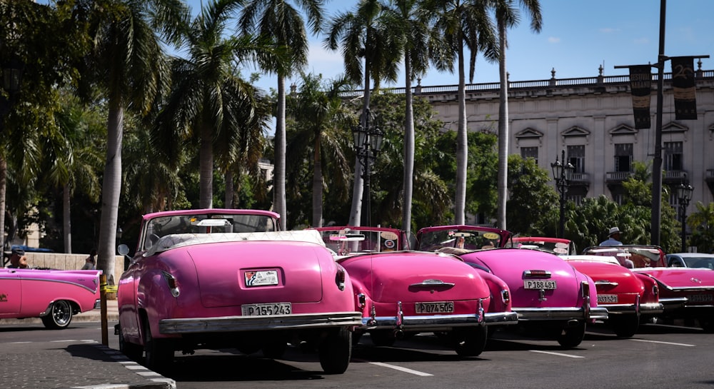 pink convertible car on road during daytime