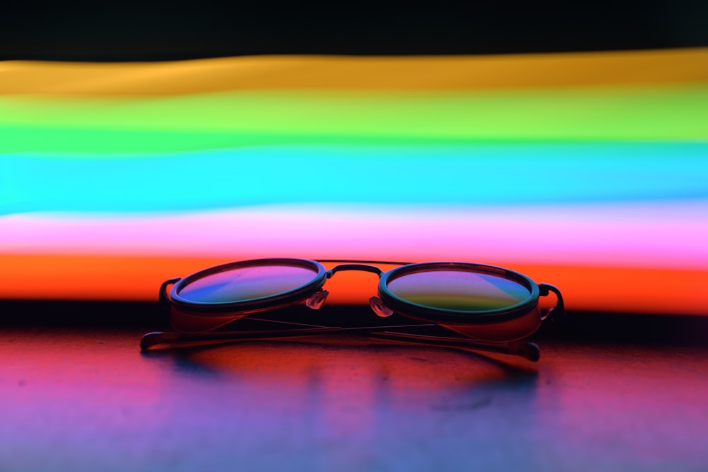 black framed eyeglasses on red yellow and blue background
