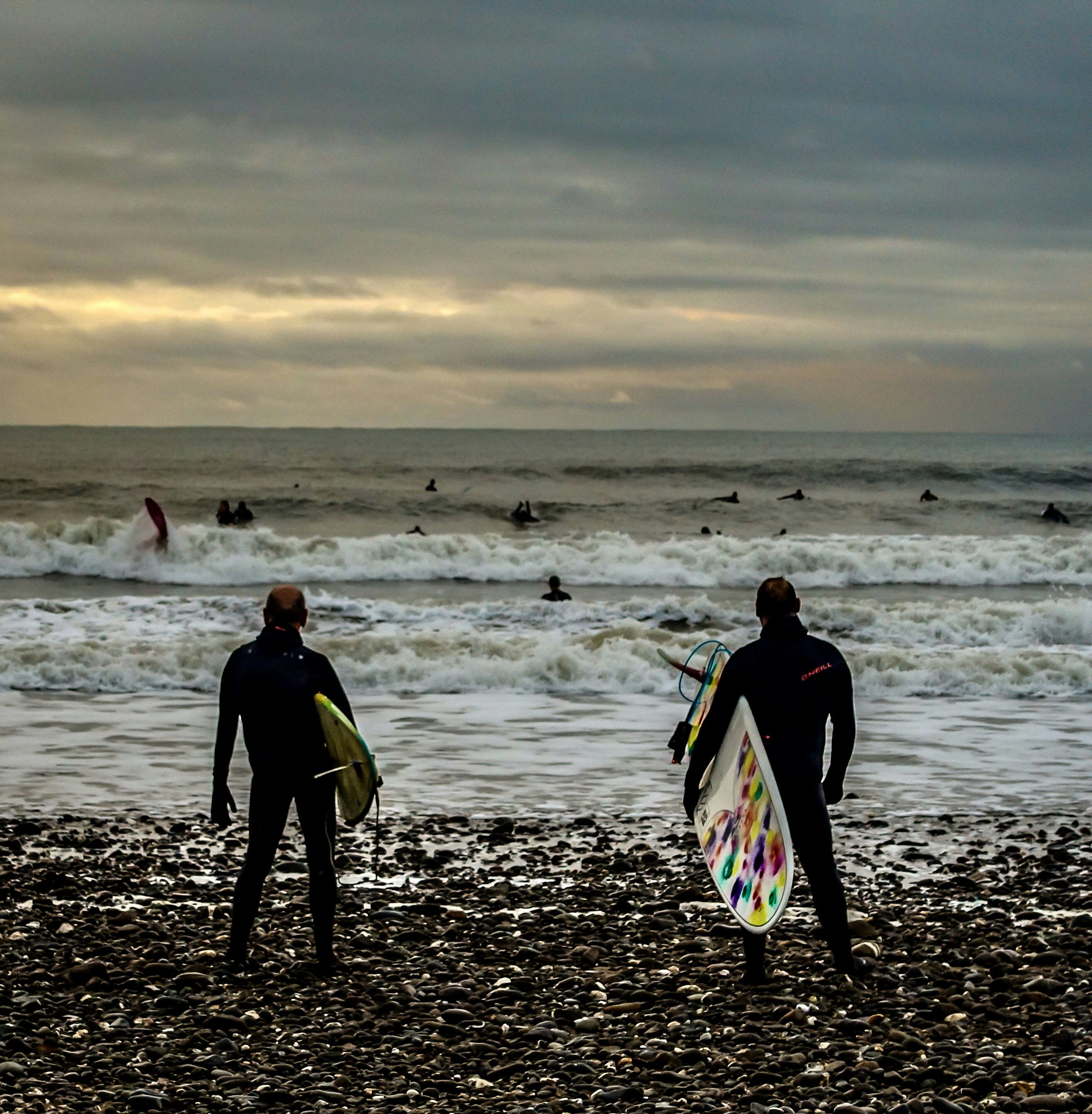 Surfers ready to catch some waves on Bude beach