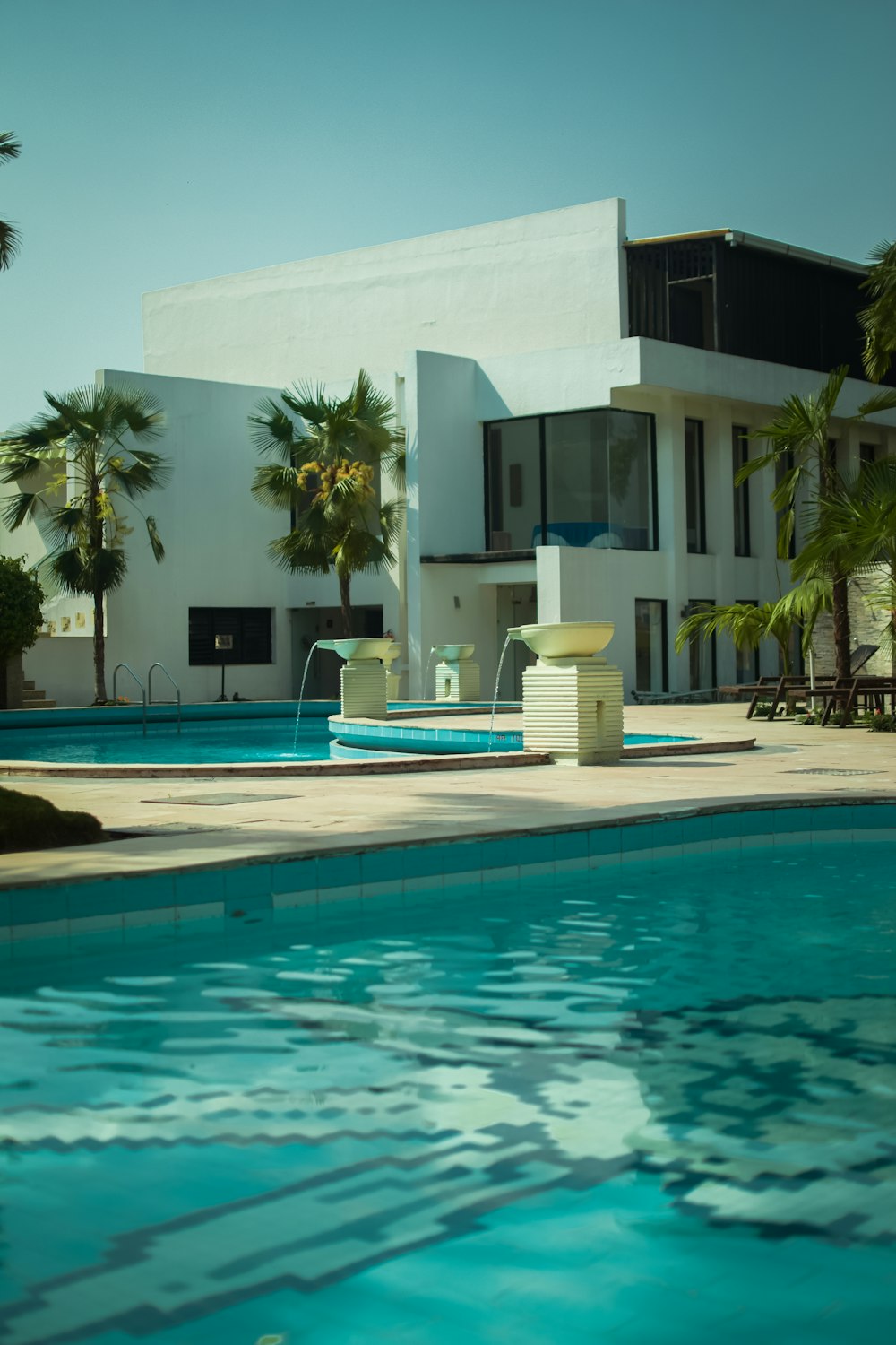 white concrete building near swimming pool during daytime