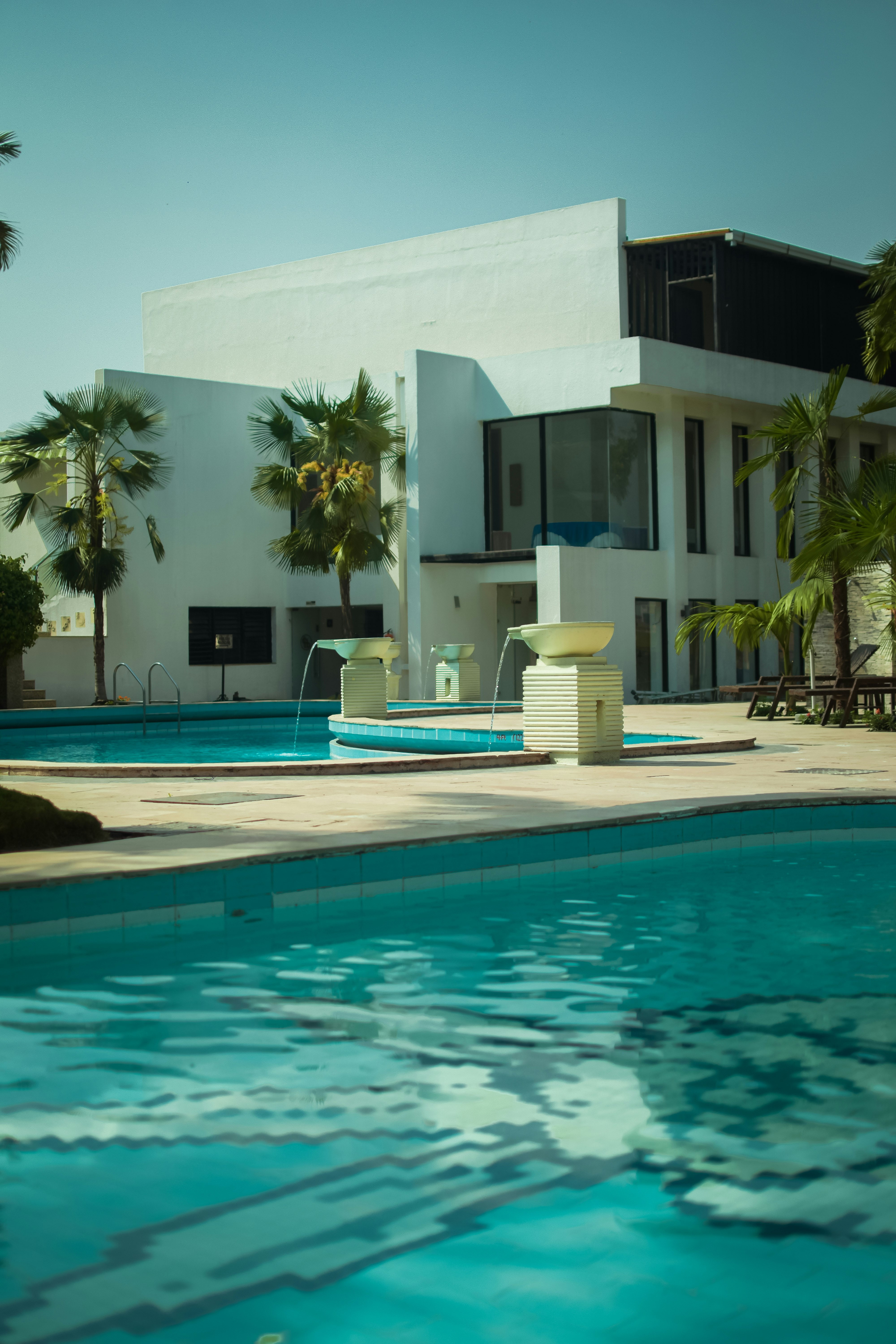 white concrete building near swimming pool during daytime