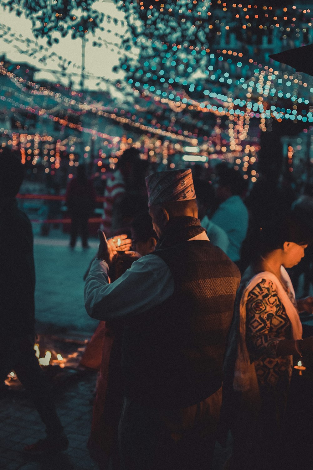 man in black hat and black jacket holding smartphone