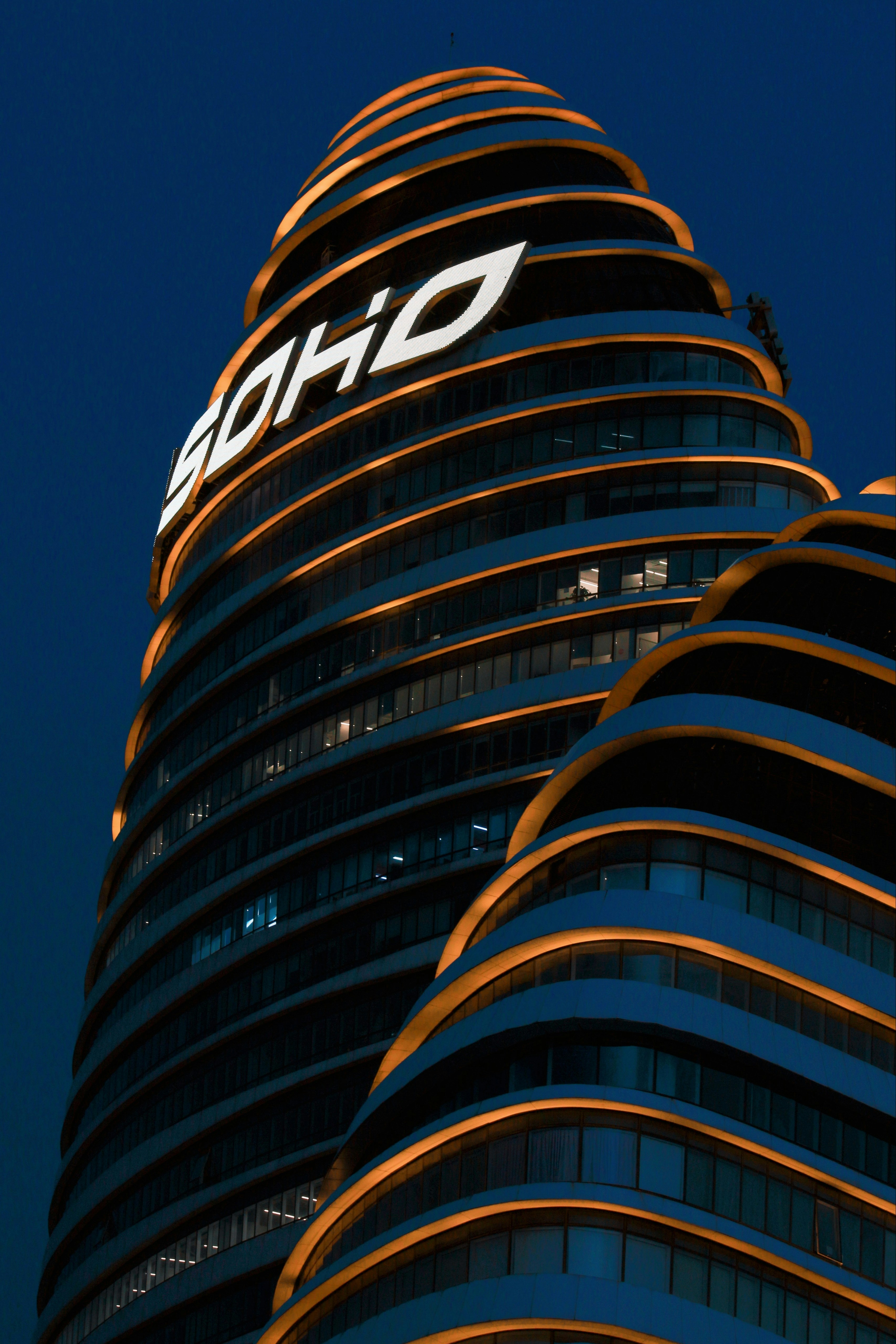A very tall building with a sign on top of it photo – Free City Image ...