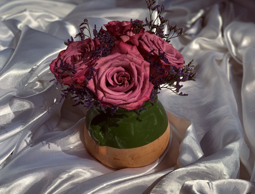 red roses in brown ceramic vase