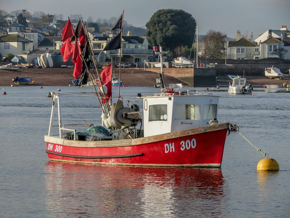 red and white boat on body of water during daytime