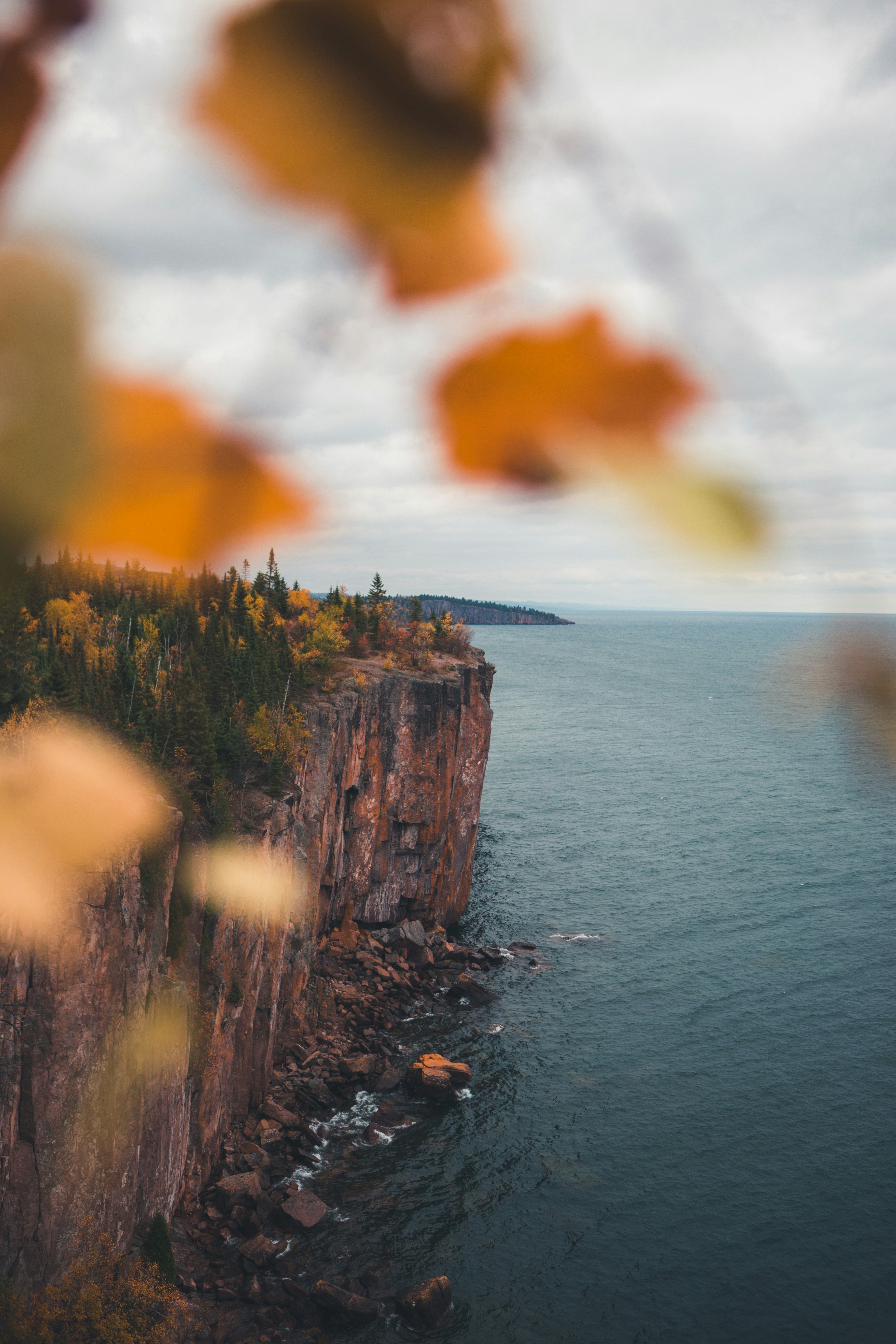 brown rock formation near body of water during daytime