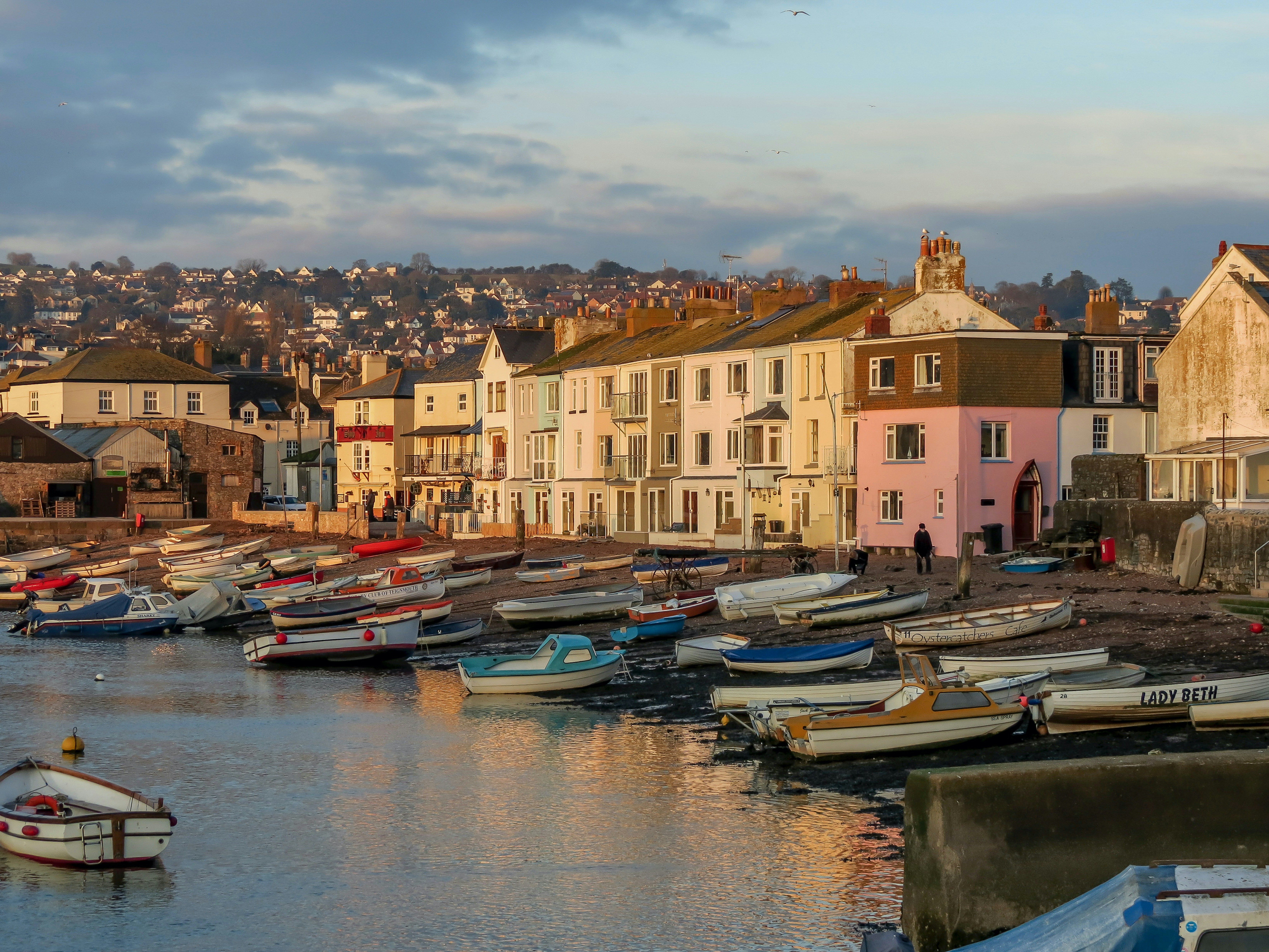 boats on dock near buildings during daytime