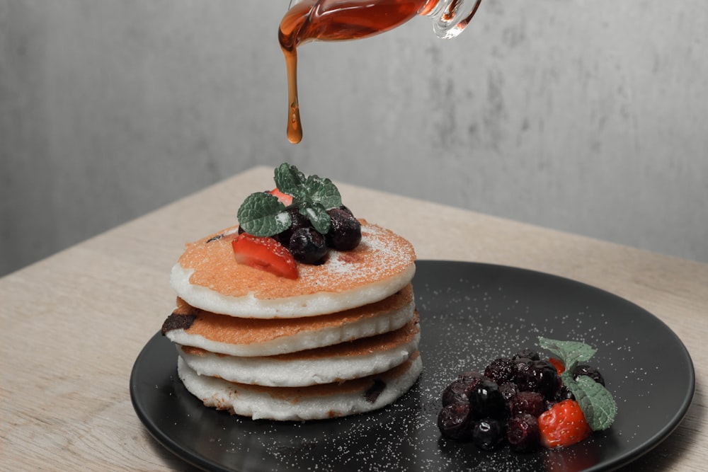 brown and white cake on black ceramic plate