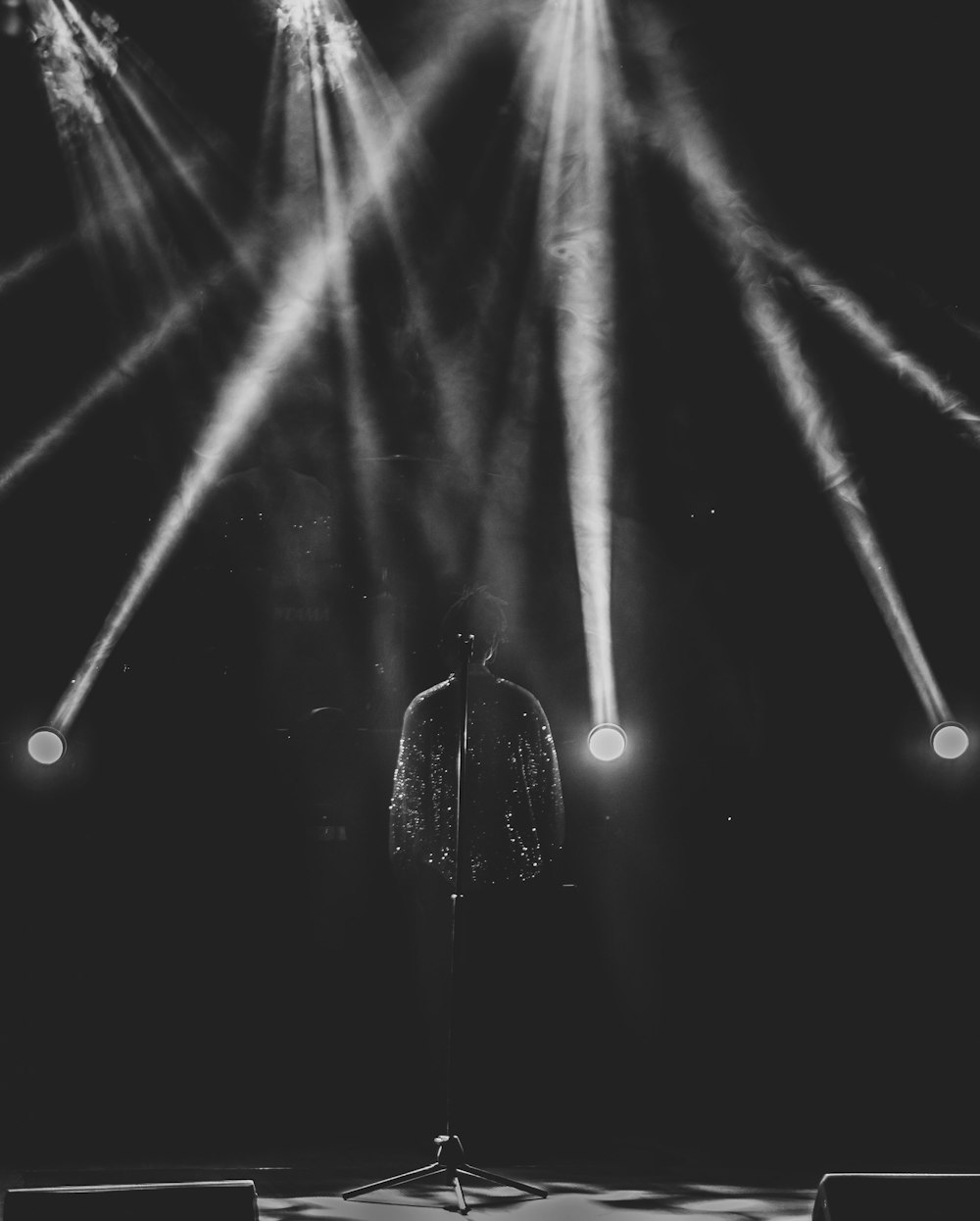 a man standing in front of a stage with lots of lights