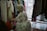 A stylish woman browsing through an array of colorful dresses in a boutique.