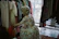 A cheerful shopper twirling in a colorful dress from Veruca's Closet inside a cozy room.
