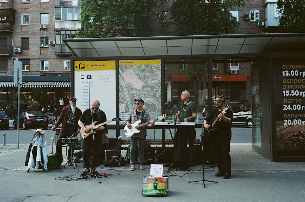 people playing musical instruments on street during daytime