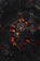 A close-up view of glowing charcoal briquettes with a warm, orange-red glow emanating from between the blackened coals. The texture of the charcoal is rough and ashy, highlighting the contrast between the dark surface and the vibrant heat.