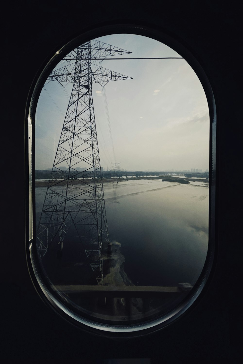 white and black tower in the middle of the sea