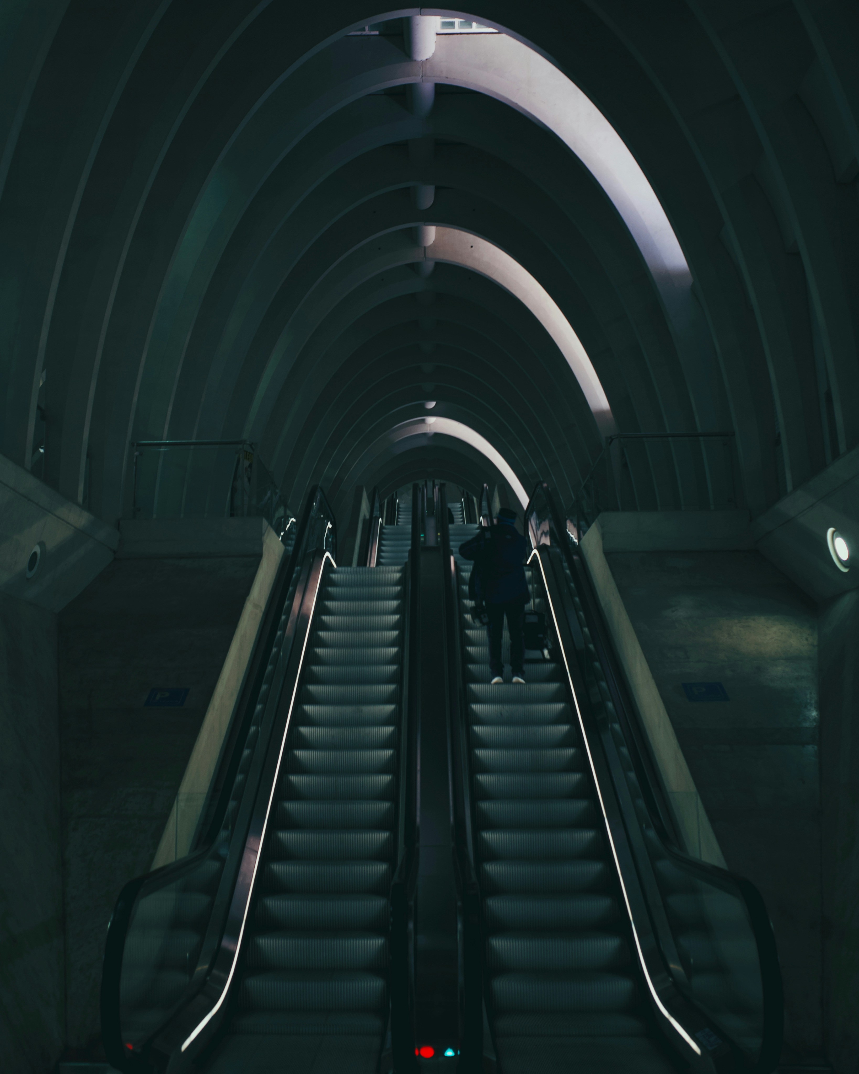 black escalator in a tunnel
