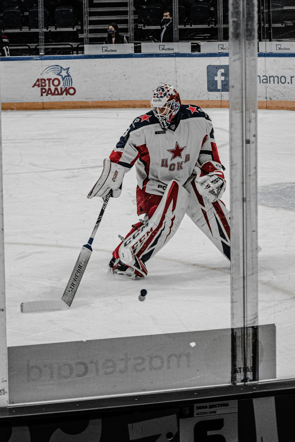 man in red and white ice hockey jersey riding on hockey stick
