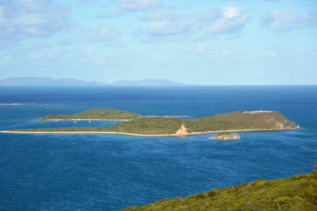 green island under blue sky during daytime