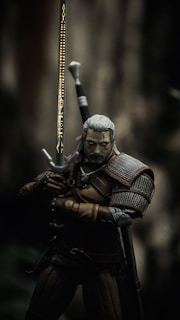 man in black and brown suit holding sword