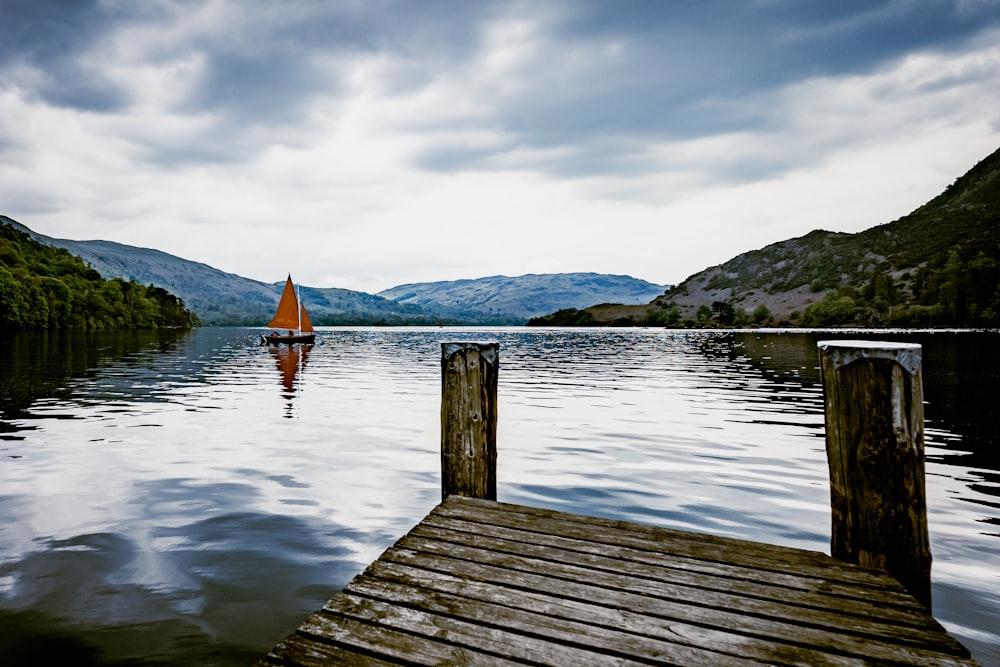 brown wooden dock on lake during daytime