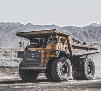 yellow and black heavy equipment on snow covered ground during daytime