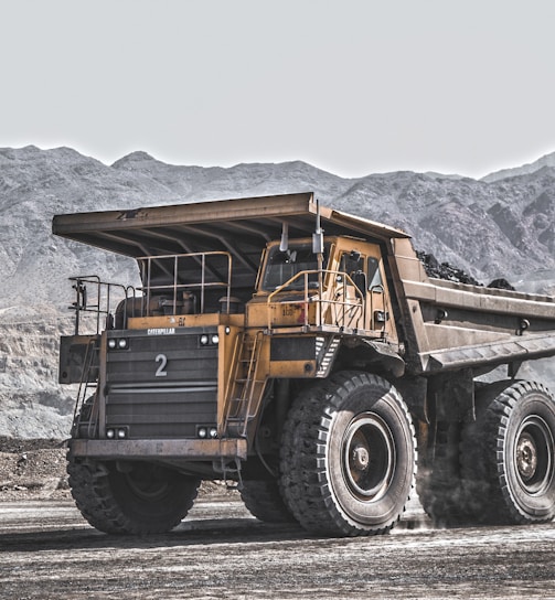 yellow and black heavy equipment on snow covered ground during daytime