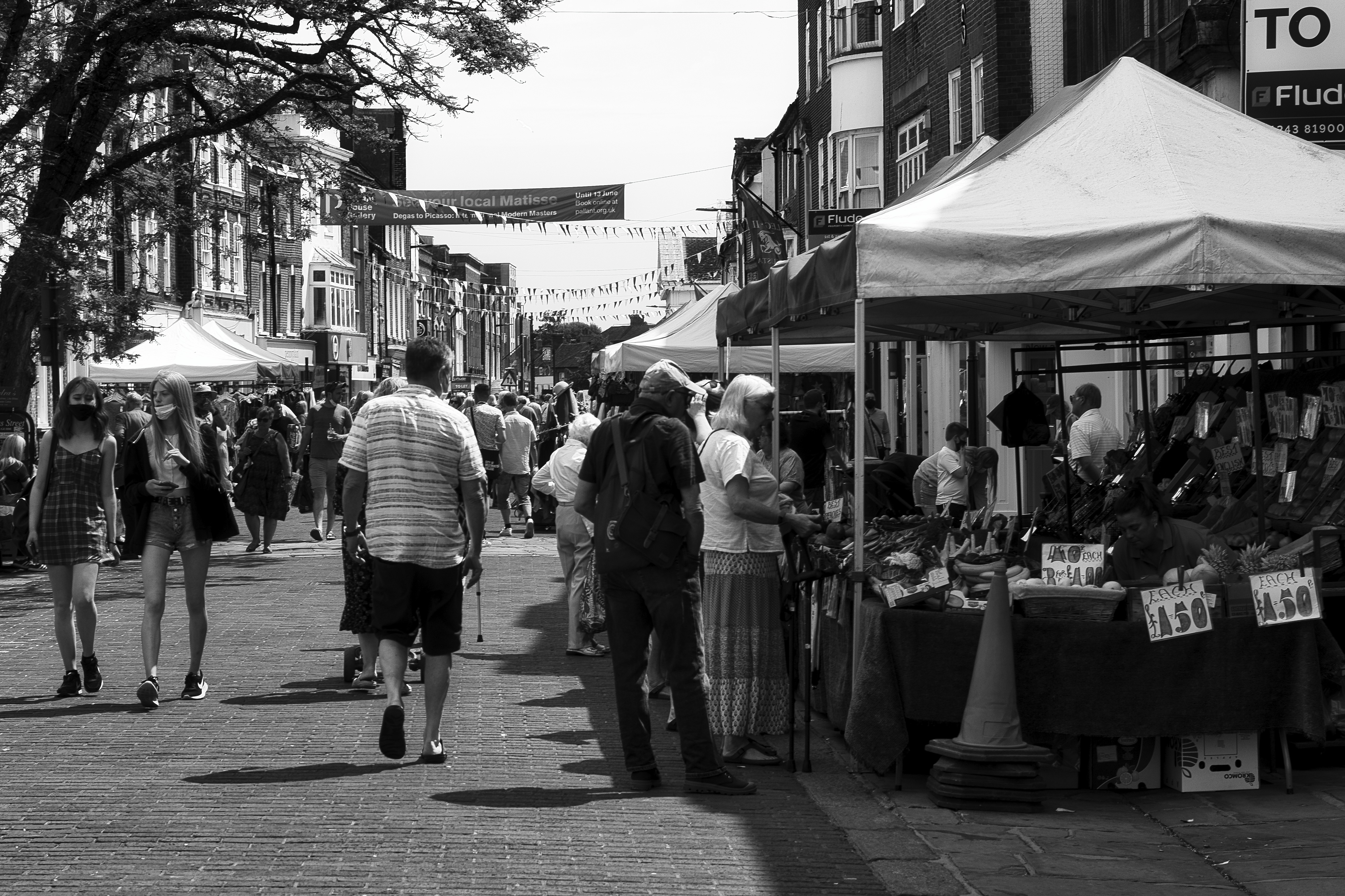 grayscale photo of people walking on sidewalk