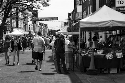 grayscale photo of people walking on sidewalk