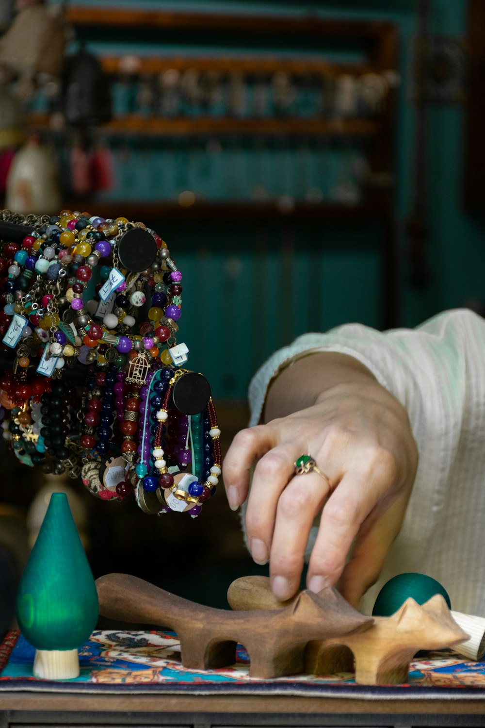 person holding green and yellow beaded accessory