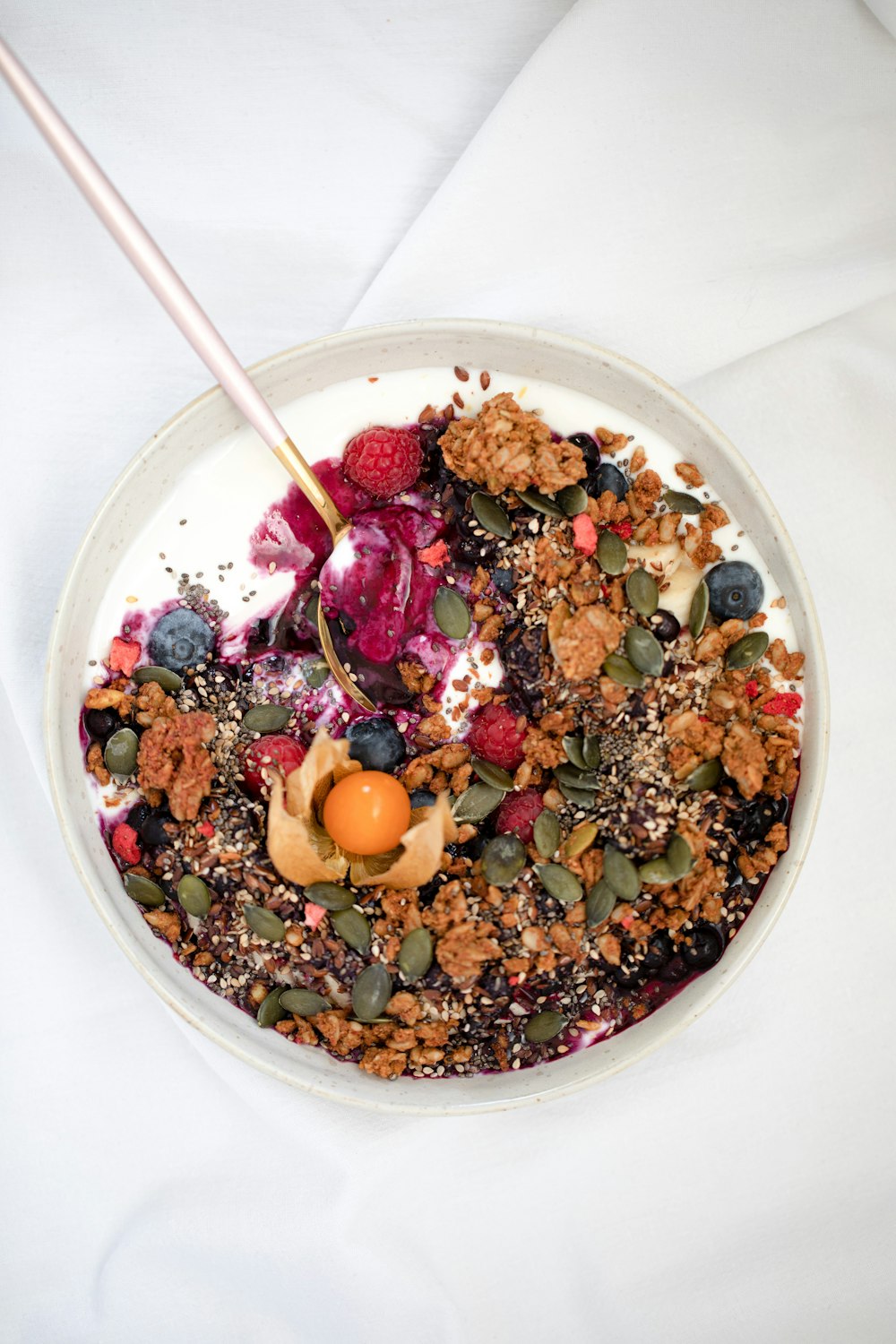 cereal with milk and sliced fruits in white ceramic bowl