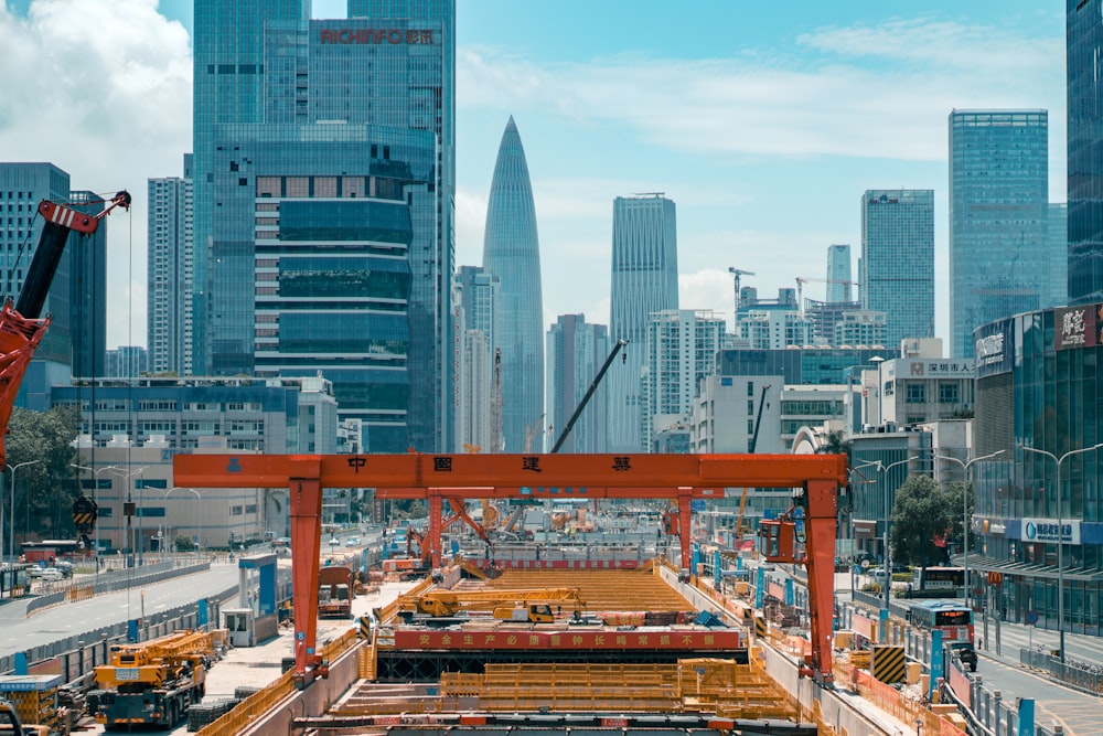 orange metal bridge over city buildings during daytime