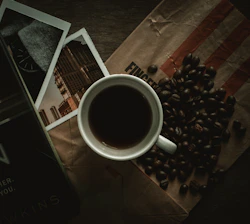 white ceramic mug on black and white table