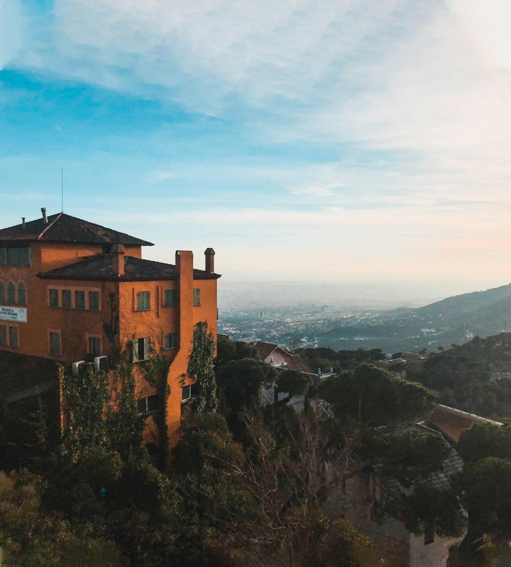 brown concrete building on top of mountain during daytime