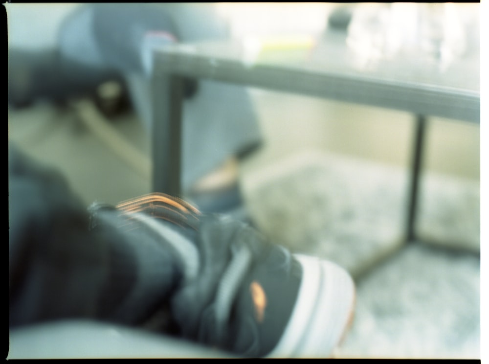 person in blue denim jeans and white sneakers