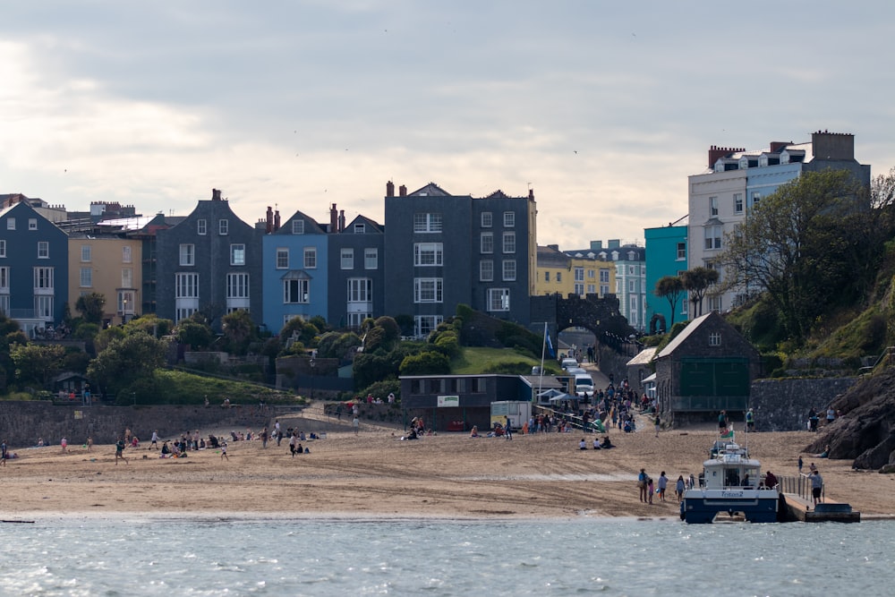 people on beach near buildings during daytime